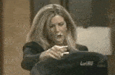 a woman is holding a jacket with the name lori hg on it
