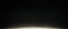 a close up of a robot 's head with a light coming out of it 's mouth .