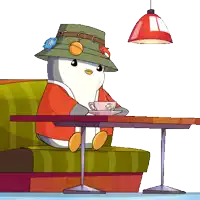 a penguin wearing a hat sits at a table with a cup of coffee on it