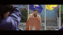 a man is giving a speech at a podium that says sav on it
