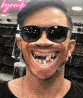 a man wearing sunglasses and a mask with the word bynwk written on the bottom