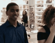 a man and a woman are standing next to each other in a store .