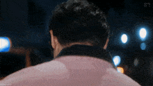 a man 's back is shown in a blurry photo with the letters s on the bottom