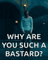 a man is standing in front of a tunnel and smoking a cigarette and asking why are you such a bastard .
