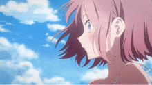 a girl with pink hair looks at the sky