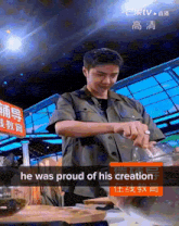 a man cooking with a sign that says he was proud of his creation