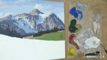 a painting of a mountain with a palette of paint next to it