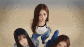a group of three girls are looking at the camera