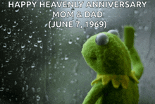 kermit the frog is looking out a window with the words happy heavenly anniversary mom & dad