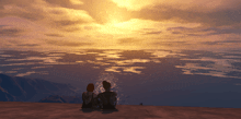 a couple sitting on a beach looking at the sunset over the ocean