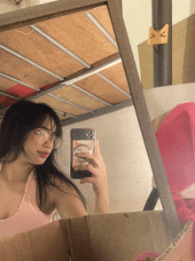 a girl taking a picture of herself in a mirror with a phone that has the number 8 on it