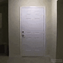 a white door in a hallway with the word cropvideo on the bottom
