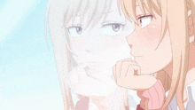 a girl with blonde hair looks at her reflection in a window