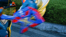 a blurred image of a person in a blue and red outfit