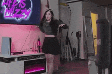 a woman is dancing in a living room in front of a tv .
