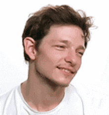 a close up of a man 's face with a white shirt on .