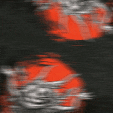 a blurred image of a monster with horns and spikes