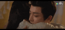 a man and a woman are hugging each other and kissing .