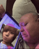 a man is crying while looking at a picture of a girl