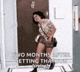 a woman is standing in front of a door and laughing while getting that job .