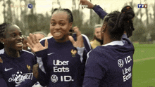 a group of female soccer players are wearing uber eats shirts