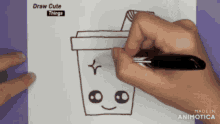a person is drawing a cup with a star on it