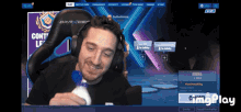 a man wearing headphones is smiling in front of a screen that says " arena "