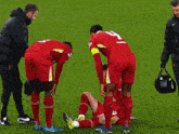 a soccer player with the number 4 on his jersey lays on the ground
