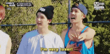 two young men are standing next to each other and one of them is saying i 'm very loser .