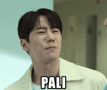 a man is making a funny face and the word pali is on his face