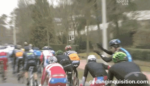 a group of cyclists are riding down a street and the website cyclinginquisition.com is visible in the corner
