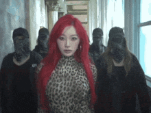 a woman with red hair wearing a leopard print top is surrounded by masked people