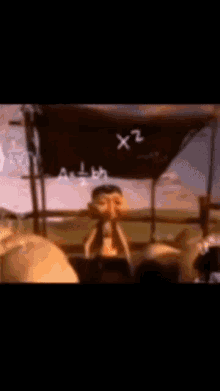a blurry picture of a cartoon character reading a book under a sign that says " x2 "