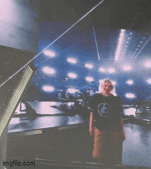 a person standing in front of a large screen with imgflip.com written on the bottom