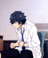 a man in a white coat and tie is sitting on a chair