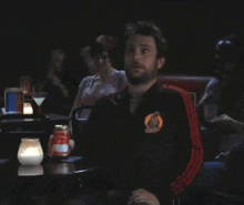 a man sitting at a table with a can of soda in front of him