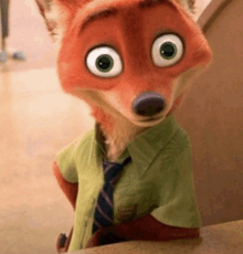 a cartoon fox wearing a green shirt and tie is sitting on a table .