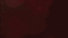 a blurred image of a person in a red shirt