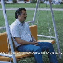 a man is sitting on a swing with the words pov when you don t get a response back below him