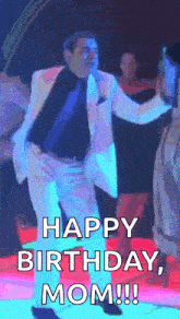 a man in a suit and tie is dancing on a dance floor and says happy birthday , mom !!!