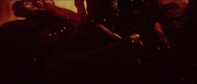 a monster is surrounded by flames and smoke in a dark room