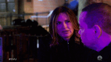 a man and a woman are looking at each other in a scene from nbc 's law and order svu
