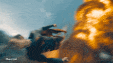 a blurred image of a man flying with #superman written on the bottom