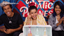a group of people are sitting in front of a sign that says plastica polinesia