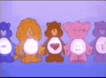a row of care bears are standing next to each other on a blue surface .