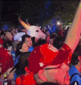 a man wearing a bull mask is surrounded by people