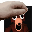 a hand is holding a piece of paper over a picture of a bear .