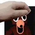 a hand is holding a piece of paper over a picture of a bear .
