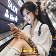 a woman wearing glasses is sitting on an escalator looking at her cell phone