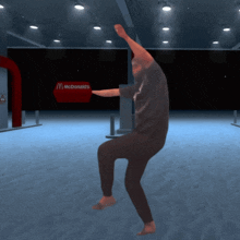 a man is dancing in front of a mcdonalds sign